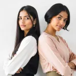 Two-Indian-women-in-their-20s-and-30s-standing-back-to-back,-representing-the-changing-symptoms-and-priorities-of-PCOS-with-age
